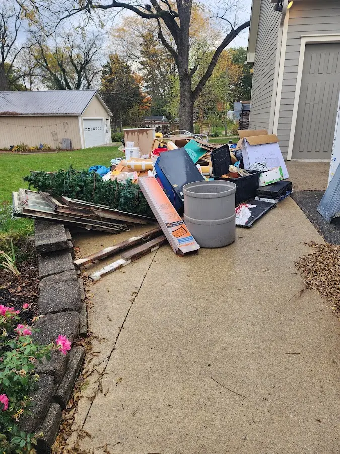 Dumpster being loaded with debris for Commercial Dumpster Rental in Sheridan